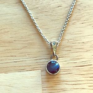Silver colored chain with small blue pendant